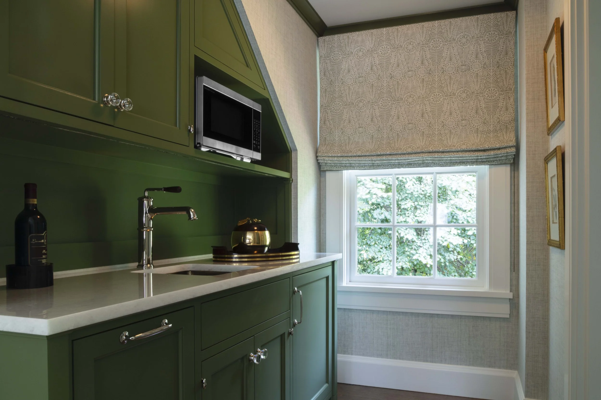Green kitchen cabinets with white countertop