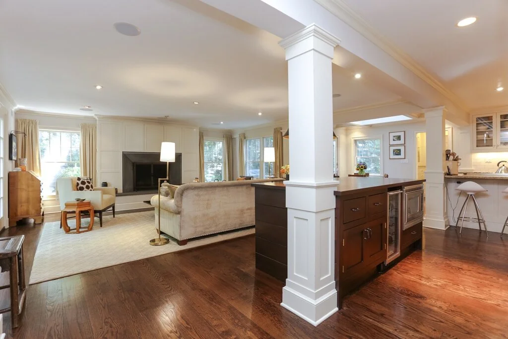 Open-concept living room and kitchen with hardwood floors