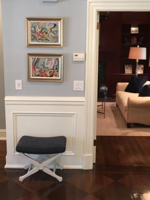 Hallway with wall art and glimpse into living room