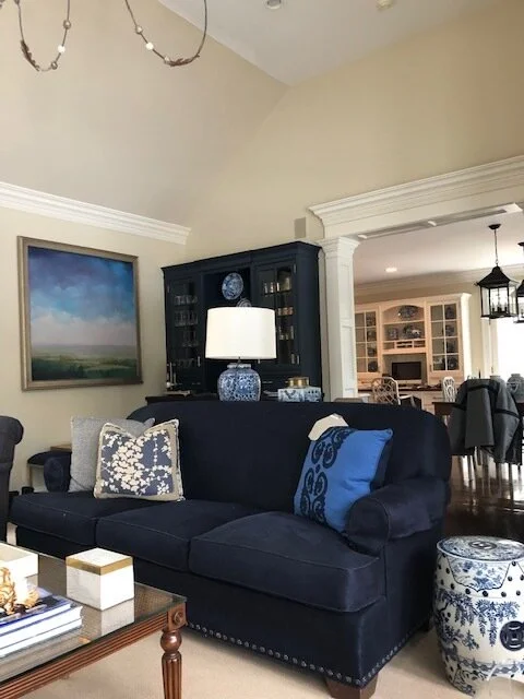 Living room with navy sofa and blue-and-white ceramics
