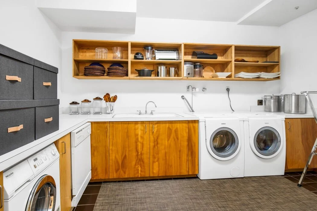 Laundry room with wooden shelving and built-in storage