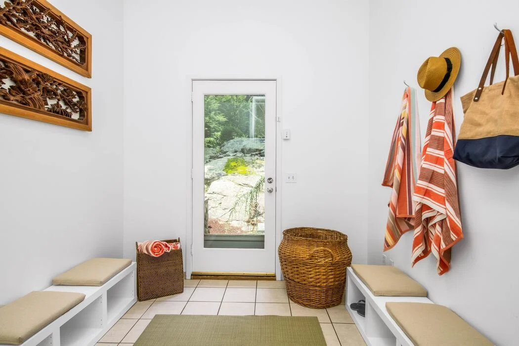 Mudroom entry with tiled floor and built-in bench seating