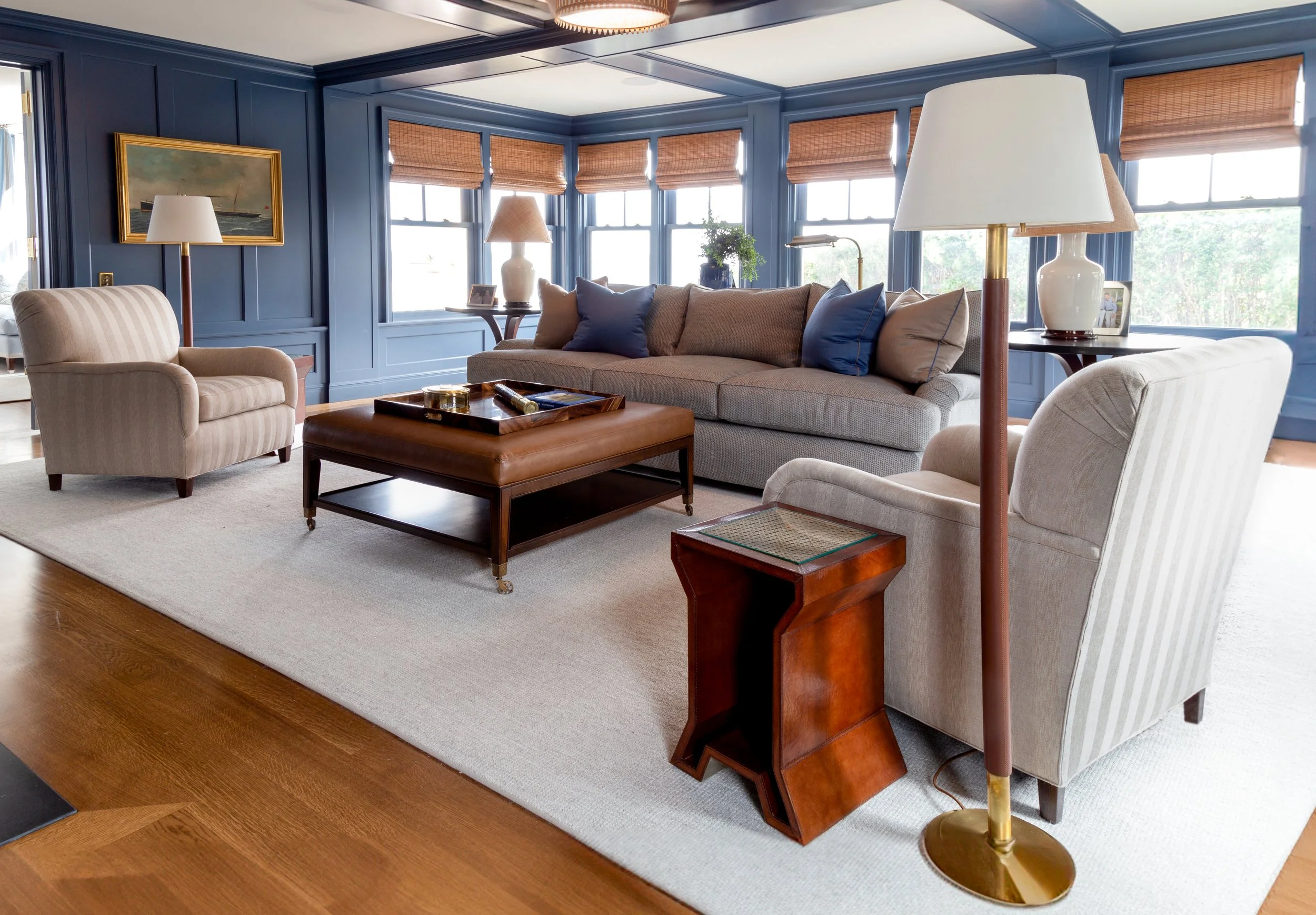 Living room with blue panelled walls and bamboo blinds